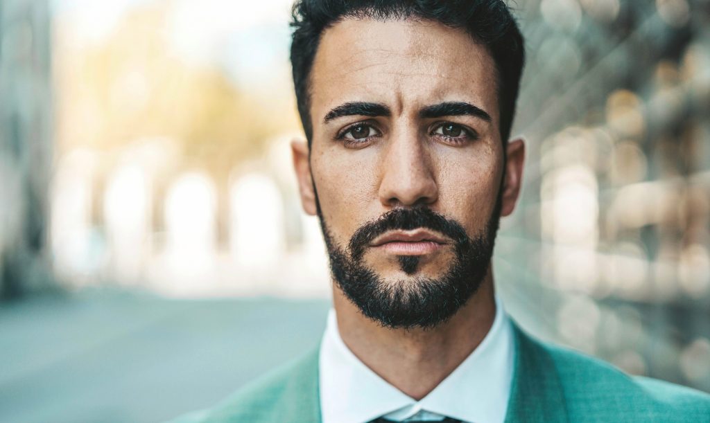 Head shot portrait of business man looking at camera outdoors